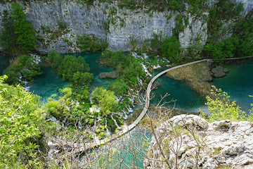 Wooden walkway bridge and waterfalls landscape with natural green mountain cliff at Plitvice Lakes National Park, Croatia UNESCO World Heritage 