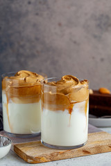 Cold dalgona coffee. Korean trend drink. Drink with cold milk and coffee cream foam in glasses.