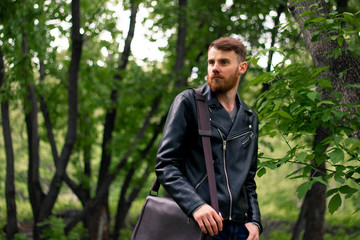 Young Irish guy with a beard in a black leather jacket.