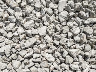 Gray pebbles stone for background in a sunny day. 