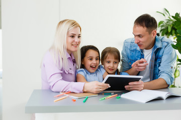 Family With Children Using Technology At Home