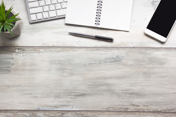 White desk office with laptop, smartphone and other work supplies with cup of coffee. Top view with...