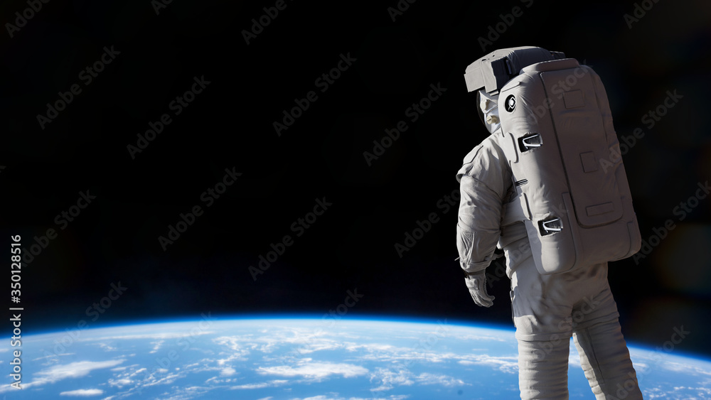 Wall mural astronaut presenting an empty space in front of planet earth