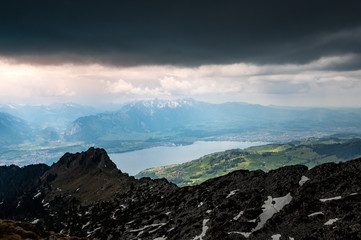 view from the peak of Sigriswiler Rothorn during a thunderstorm with Thun and Lake Thun