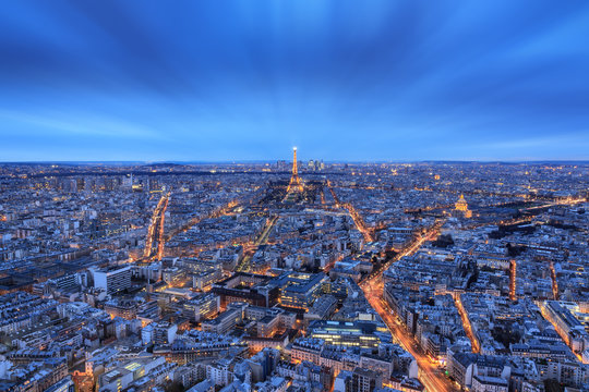 Beautiful aerial skyline cityscape of Paris, France, after sunset in the blue hour, with the Eiffel tower, seen from the Montparnasse skyscraper