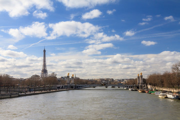 Beautiful cityscape of the river Seine with the Pont Alexandre III bridge and the Eiffel tower in Paris, France, with clouds in spring - 350130782
