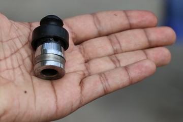 Pressure cooker whistle held in hand