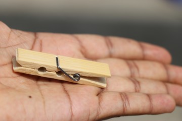 Cloth hanging clip made of wood held in hand