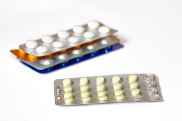 Pills in a blister pack close-up. Painkillers. Protection from coronovarus Covid19. Colored tablet packages. Medicine for the first-aid kit.