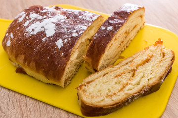 Sweet pastry, pie bun with red sweet strawberry jam inside slices of dessert with powder
