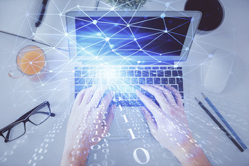 Multi exposure of man's hands typing over computer keyboard and data theme hologram drawing. Top view. Technology concept.