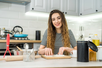 A woman kneads the dough with different ingredient. Healthy family food