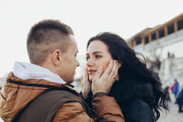 A loving couple, a guy touches the girl’s face with his palms and they gaze at each other with a look full of love and sincerity. Close-up. - 350137550