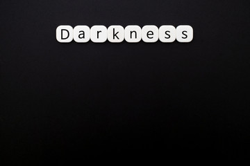 Alphabet darkness word block with black background.
