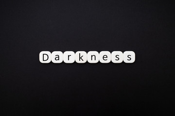 Alphabet darkness word block with black background.