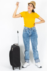 Happy young Asian woman with luggage over white isolated background. Ready for summer vacation