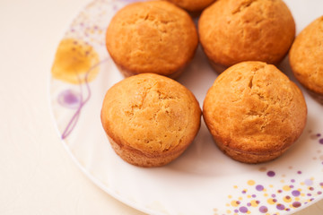 Homemade cupcakes lie on a white plate