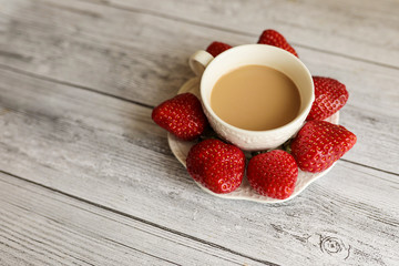 cup of coffee with milk and red strawberry