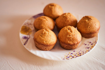 Homemade cupcakes lie on a white plate