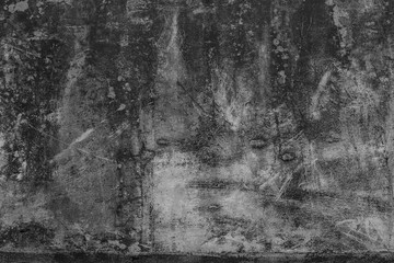 Cement wall with black fungus attached to the pattern.