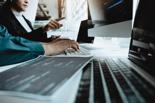 Developing programming and coding technologies working in a software engineers developing applications together in office.