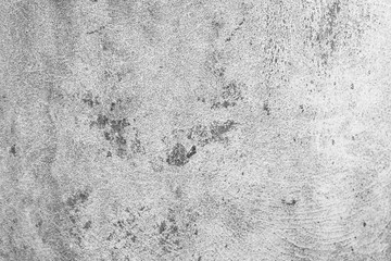 Cement wall with black fungus attached to the pattern.