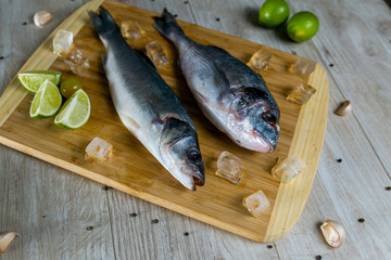 dorado and sibas fish on wood plate 