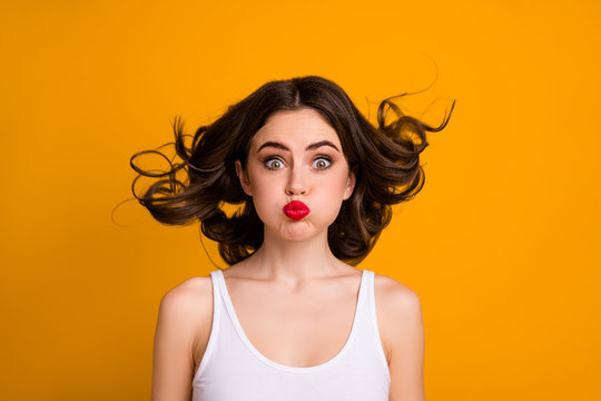 Closeup photo of funny crazy childish lady hairstyle flight mouth lips closed hold breath not breathing wear white casual tank-top isolated yellow color background