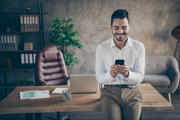 Portrait of his he nice attractive cheerful cheery man shark ceo boss chief chatting online with partner at modern loft industrial style interior work place station indoors