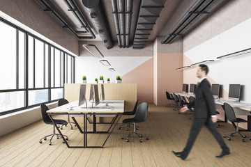 Businessman walking in office interior hall