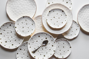 Beautiful plates on a white background with cotton. Beautiful layout