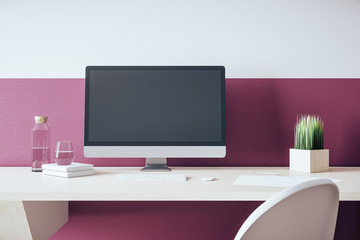 Modern designer desktop with empty black computer screen.
