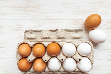 Free-range organic white and brown eggs in recycled cardboard box