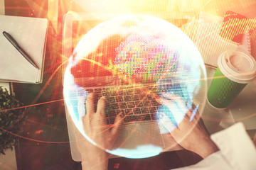 Double exposure of woman hands typing on computer and business theme hologram drawing. Success...