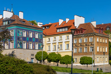 Fototapeta na wymiar Panoramic view of historic, richly decorated colorful tenement houses at Bugaj, Mostowa and Brzozowa streets of Starowka Old Town quarter in Warsaw, Poland