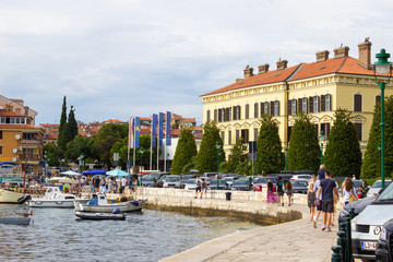 Fototapeta na wymiar Rovinj, Croatia; 7/18/2019: Picture of the port of Rovinj, Croatia, with a lot of boats on the Mediterranean Sea and the town at the background