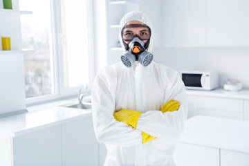 Portrait of successful worker cleaner man in coverall cross hands ready for covid19 epidemic...
