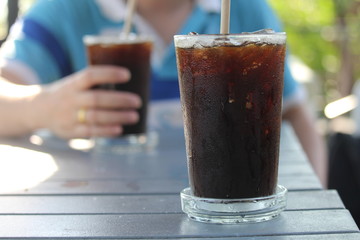 Male customers are eating coffee in a coffee shop with good atmosphere.

