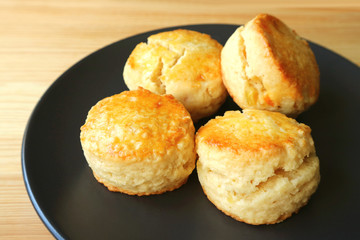 Plate of Delectable Homemade Candied Orange Zest Scones on Wooden Table