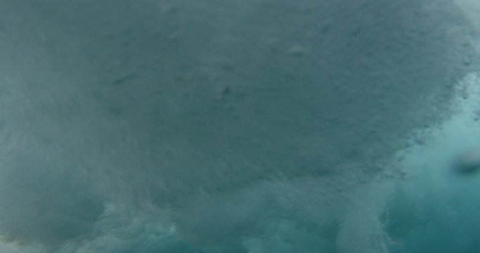Under water shot waves and barrel from behind red camera slowmtion