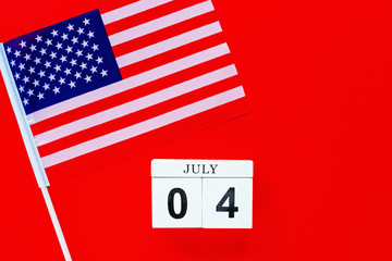 July 4th. Mockup of july 4 wooden color calendar on red background. Copy space for text. Independence Day Of America. Flat lay, top view, template