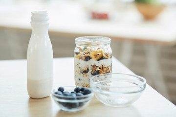 Close up background image of healthy granola dessert with yogurt on kitchen table, copy space