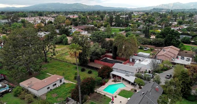 People Stay At Home In North Hills, San Fernando Valley, Los Angeles, California, USA During Coronavirus Pandemic To Prevent Spreading Of The Disease - Aerial Shot Tracking Forward Over Suburban Homes