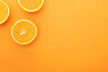 top view of ripe juicy orange slices on colorful background with copy space