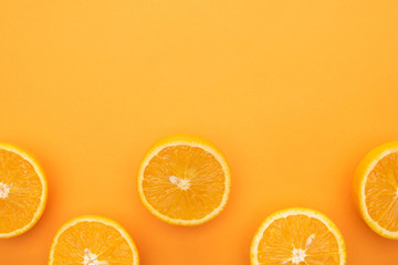 top view of ripe juicy orange slices on colorful background with copy space