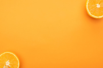 top view of juicy orange slices on colorful background