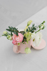 A small bouquet of beautiful flowers in a cup. Flower concept.