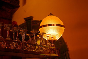 Glasses and lamp above a bar