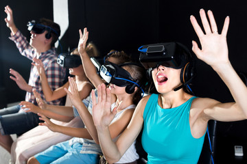 Woman is fascinated by movie in virtual reality glasses