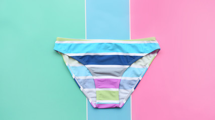 close up of bikini swimsuit on colorful background